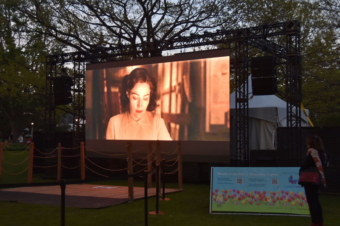 Outdoor movie display with a woman onscreen
