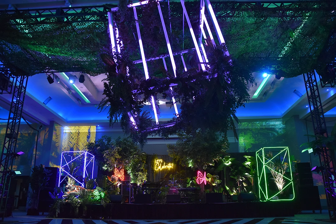 A lush jungle display at the Caivan Gala is light up with large light installations of blue, purple and green cubes made with tube lights.
