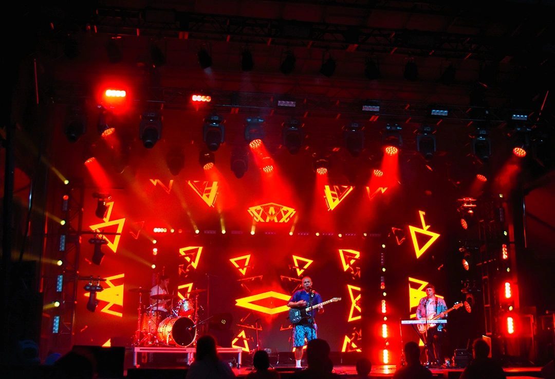 Capital Pride performers onstage with red and yellow lighting