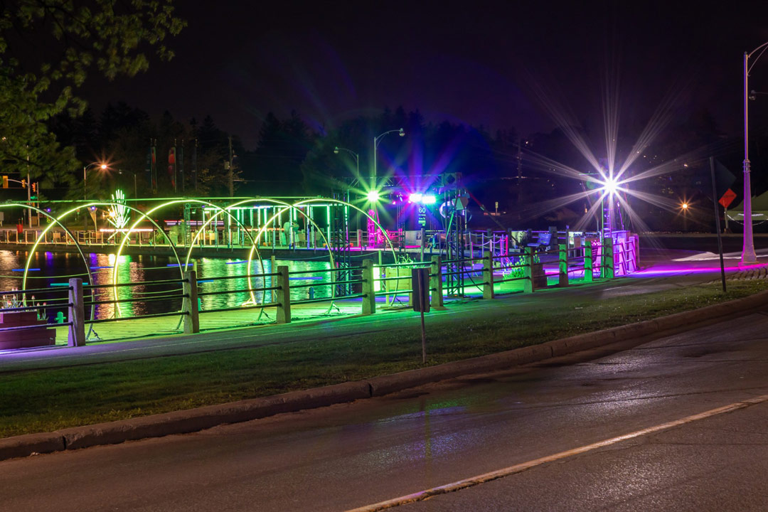 The boardwalk at Ottawa's Dow's Lake is lit up with green, yellow and pink lighting for the Tulip Festival