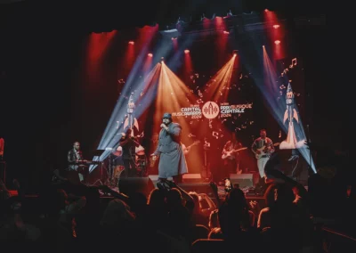 OSE Event Portfolio Photos - Capital Music Awards performers with orange backlighting and video wall behind the musicians