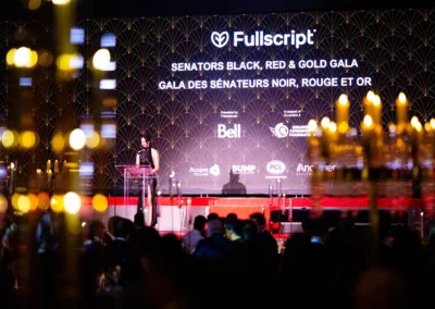 OSE Event Portfolio Photos - Sens Gala Stage with an art deco pattern backdrop on a video wall.